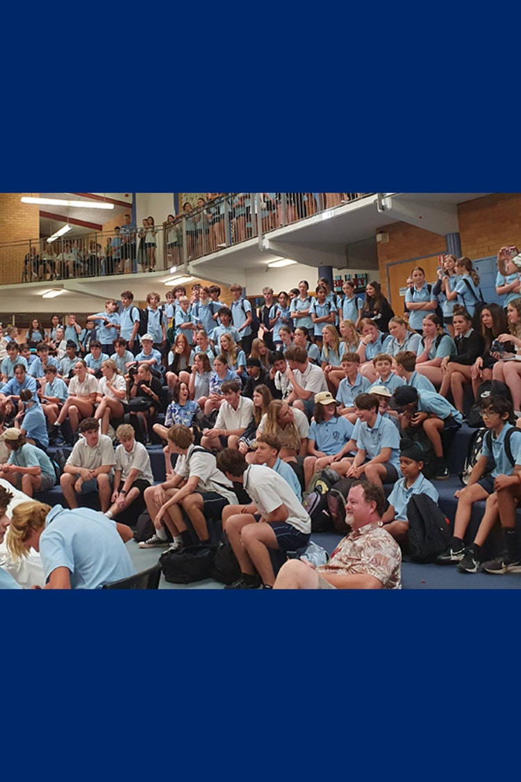 A large group of students sitting in the school forum.