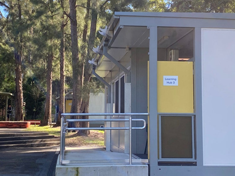 Demountable buildings with ramps in amongst trees